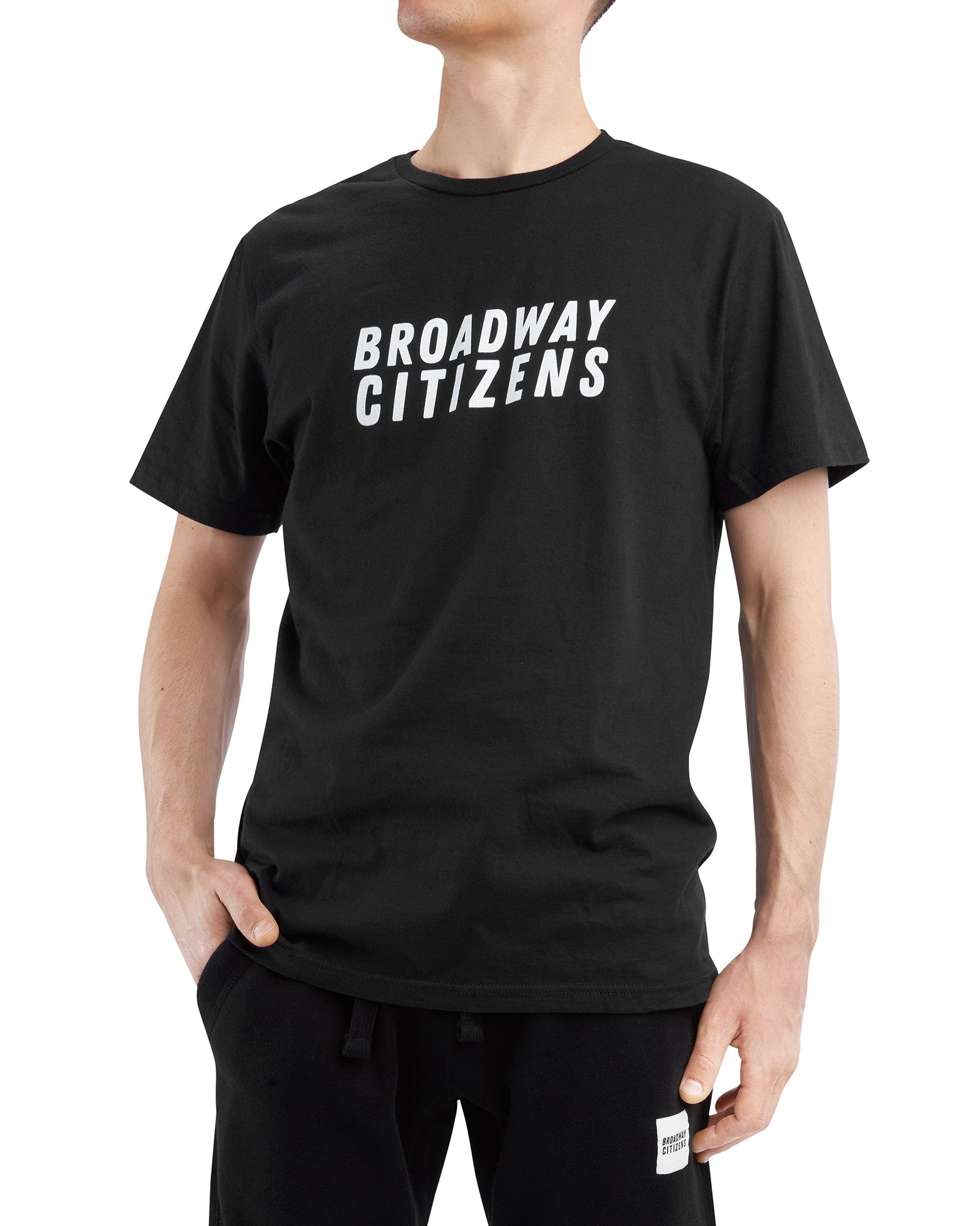 Person wearing a black t-shirt with 'BROADWAY CITIZENS' text on a white background